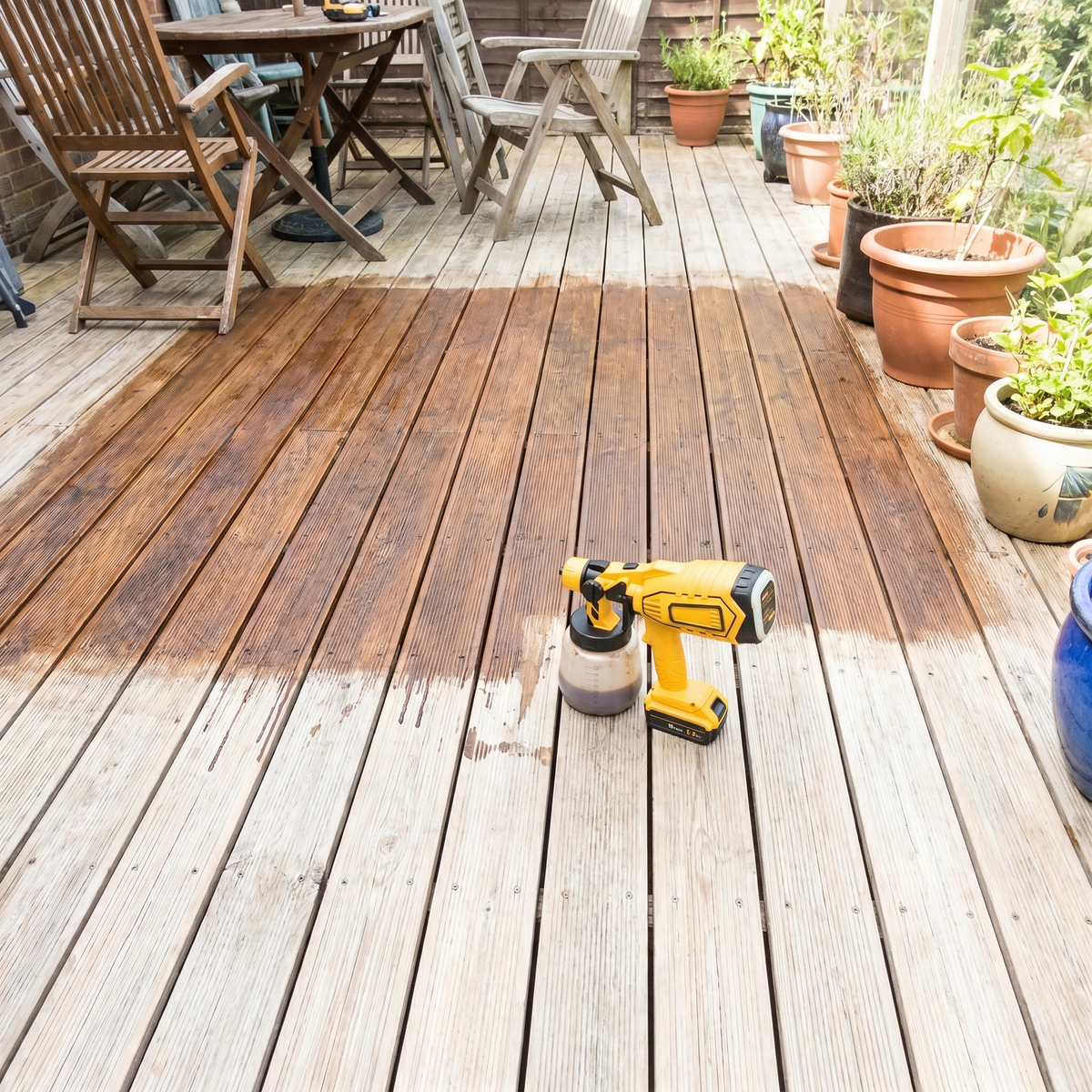 Sprayer on a stained timber deck – DeWalt-compatible