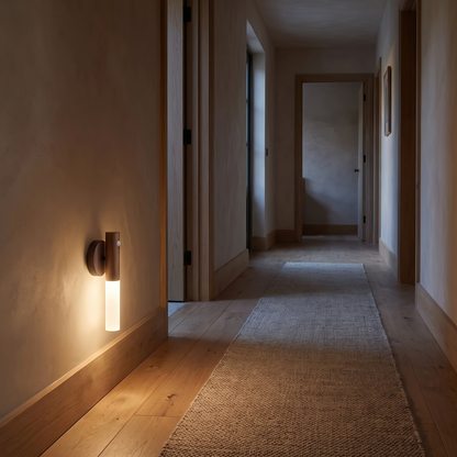 Motion sensor light glowing low on a hallway wall at night