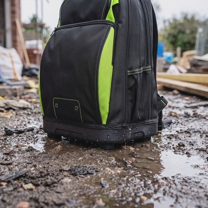 Tool backpack standing on its waterproof base on a wet site